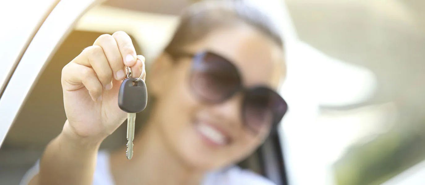 woman holding car key