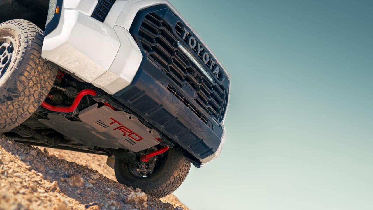 close up view underneath a white Toyota truck