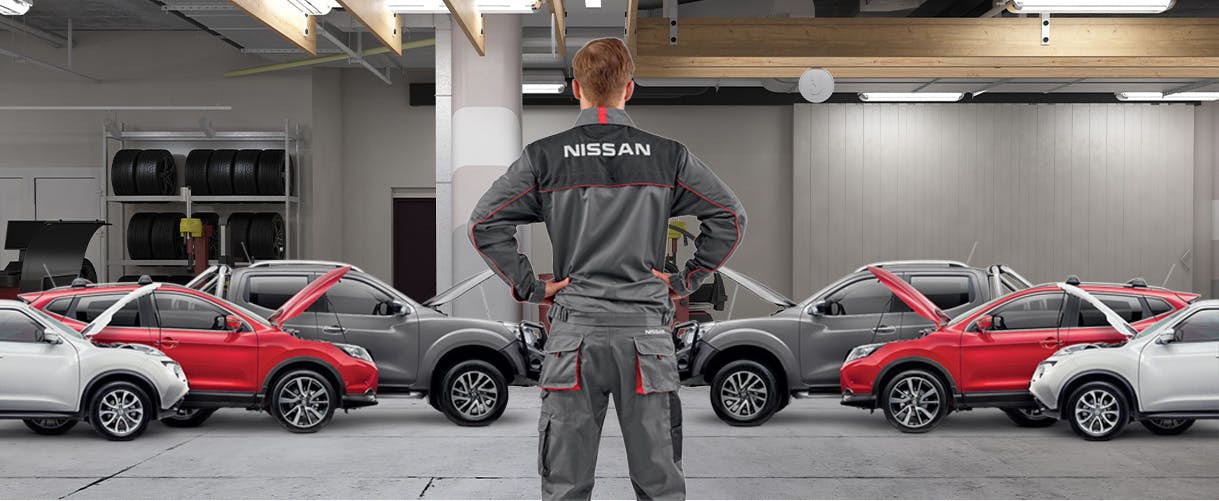Nissan tech looking at his parked cars