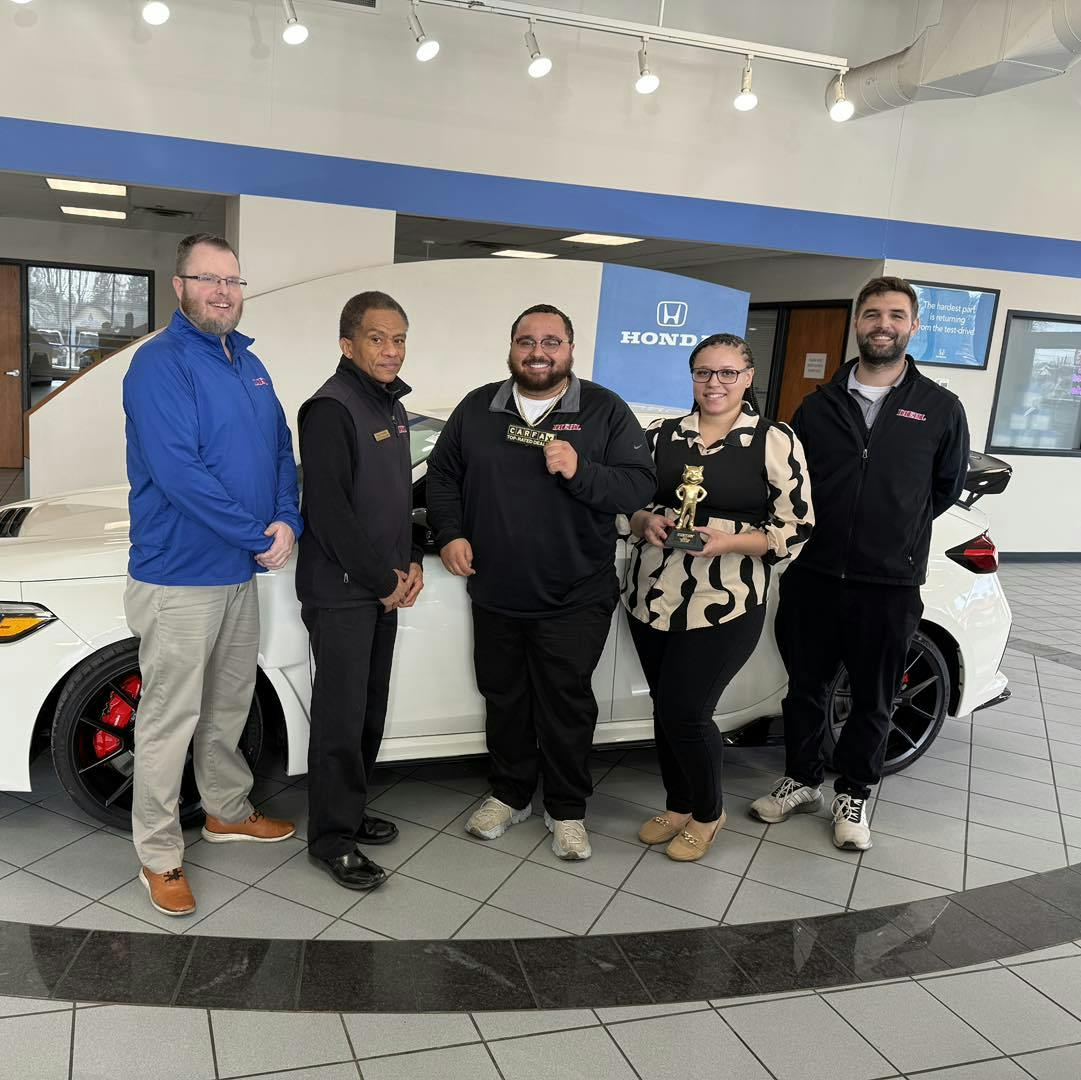 Diehl Honda of Massillon's sales team with the Carfax Top-Rated Dealer for 2024 Award