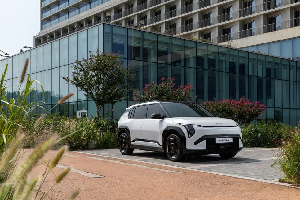 2026 Kia EV3 parked in front of a glass building