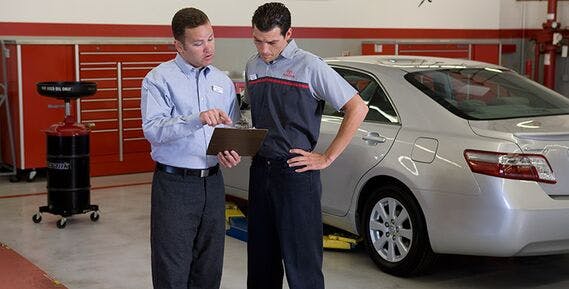 Two Toyota Service professionals look over a report
