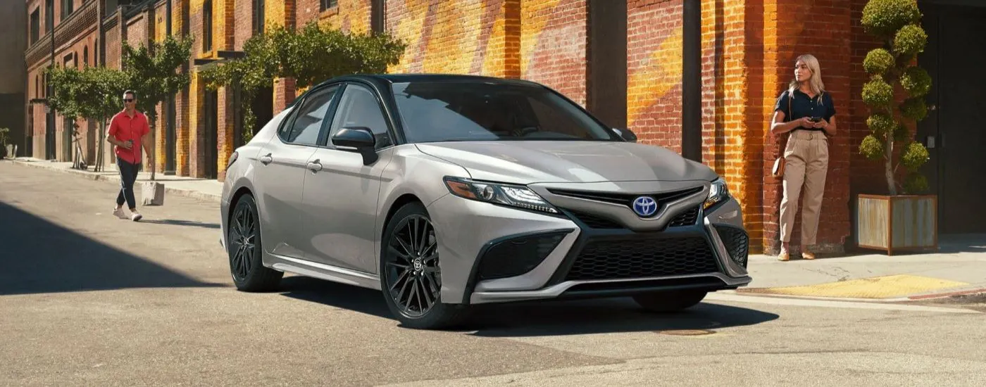 Silver 2022 Toyota Camry XSE parked in front of a brick building