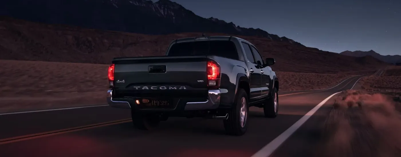 Black 2023 Toyota Tacoma SR5 driving on a highway