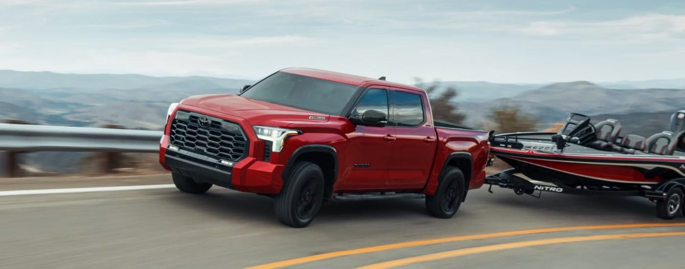 A red 2025 Toyota Tundra for sale from the side.