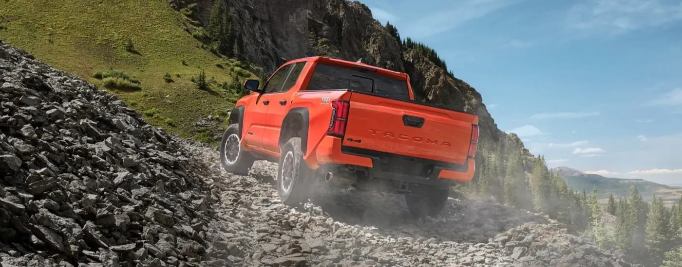 Orange 2024 Toyota Tacoma TRD for sale near El Reno driving off-road