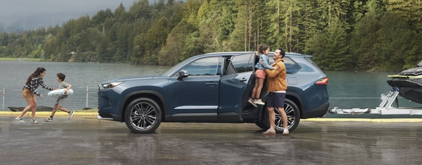 A blue 2026 Toyota Grand Highlander from the side.