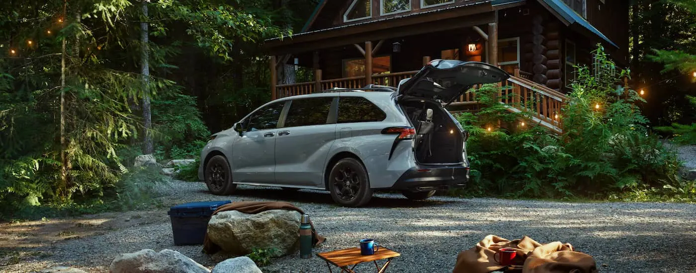 Silver 2025 Toyota Sienna parked in front of a house.