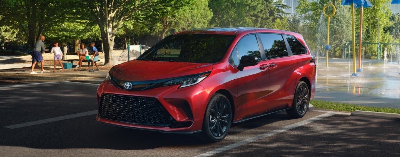 A red 2025 Toyota Sienna from the front at an angle. after leaving a dealer that has a used Toyota for sale in Oklahoma City.