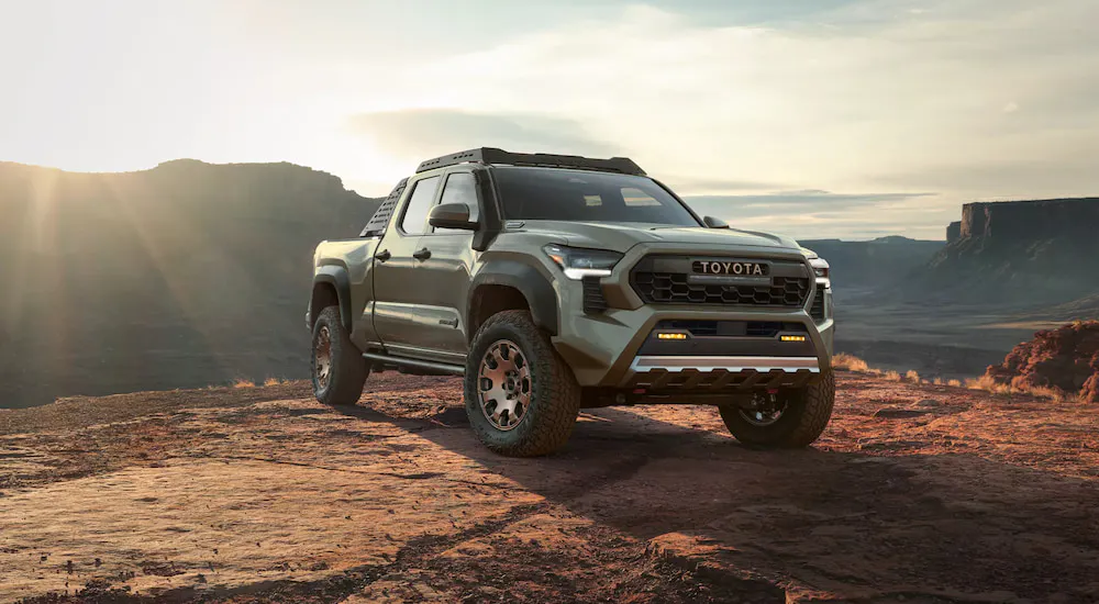 Grey 2026 Toyota Tacoma parked off-road on a hill.