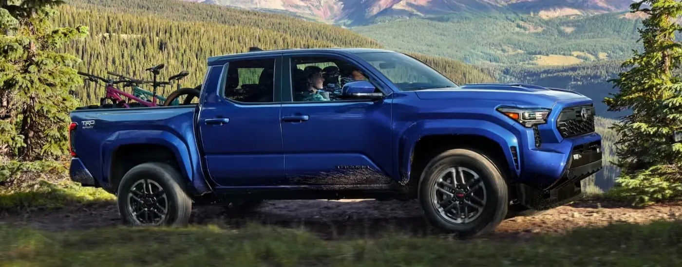 Blue 2026 Toyota Tacoma driving off-road 