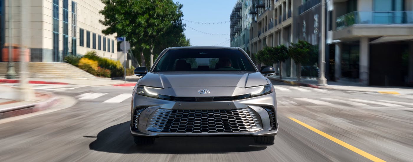 Grey 2026 Toyota Camry driving through a city