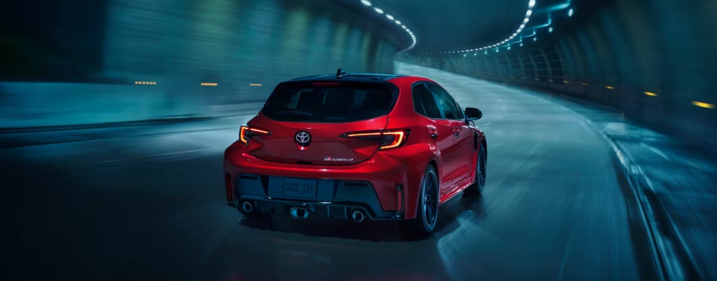 Red 2026 Toyota GR Corolla Hatchback driving through a tunnel