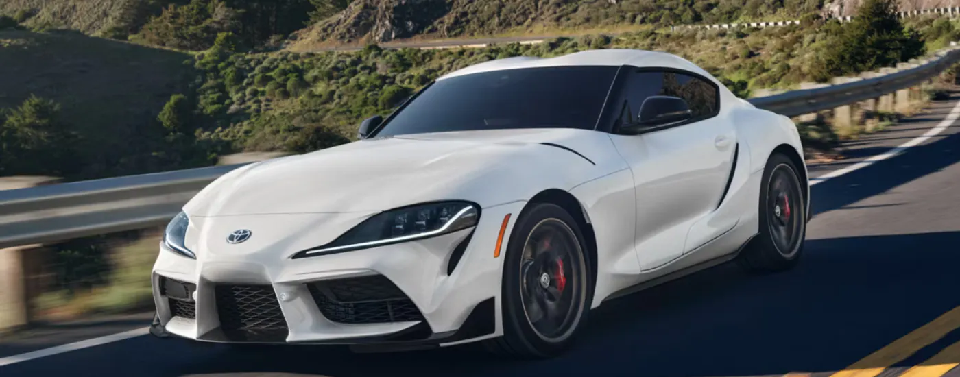 White 2026 Toyota GR Supra driving along an open road