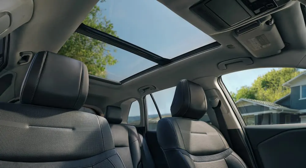 The sunroof and front seats in the interior of a 2026 Toyota RAV4.