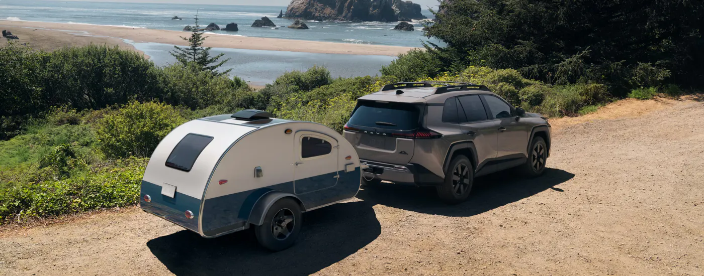 Grey 2026 Toyota RAV4 towing a camper