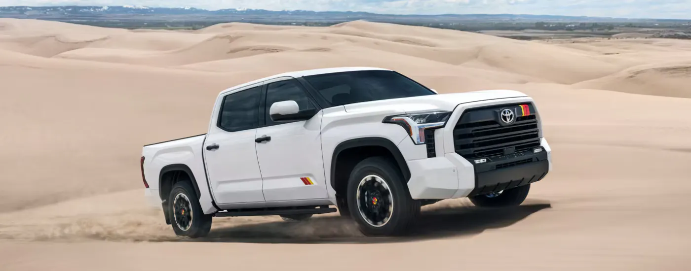 White 2026 Toyota Tundra Rally driving on a sand dune