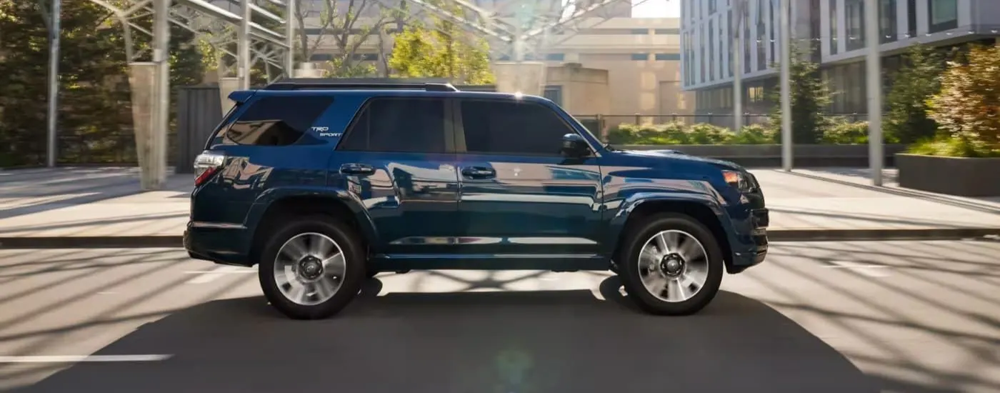 Blue 2023 Toyota 4Runner TRD Sport driving through a city
