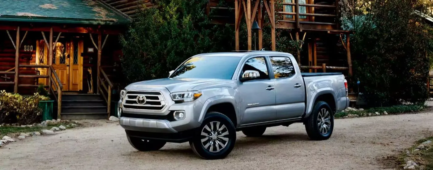 Silver 2023 Toyota Tacoma Limited parked in front of a house