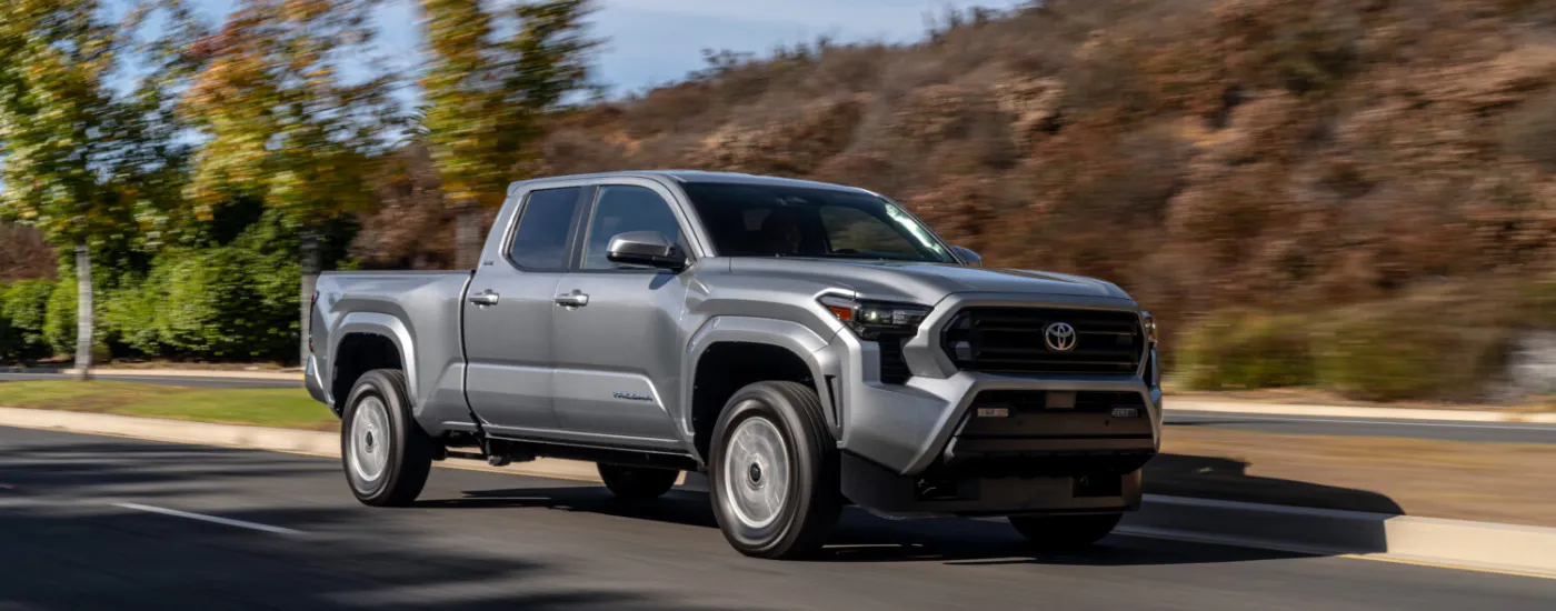 Silver 2026 Toyota Tacoma driving down an open road