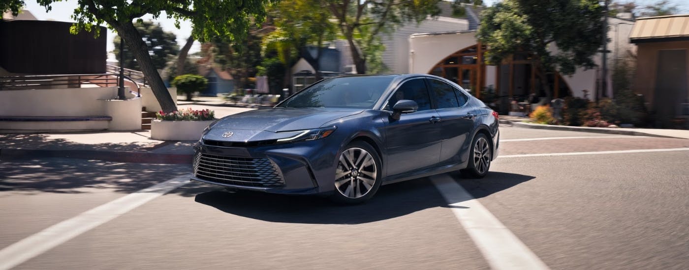 Blue Toyota Camry for sale rounding a corner