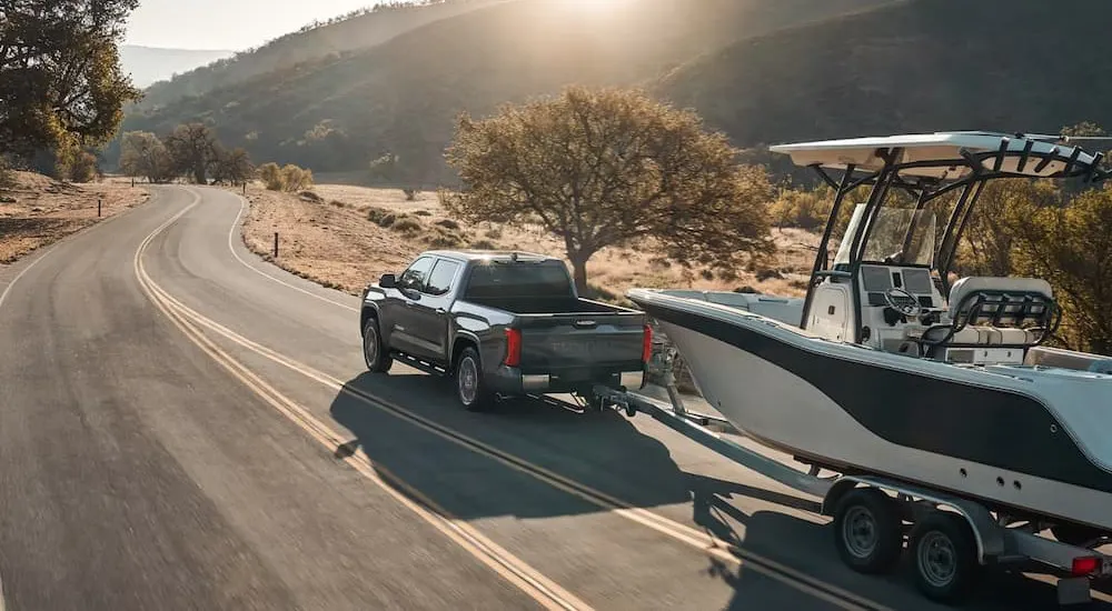 A gray 2026 Toyota Tundra towing a boat.