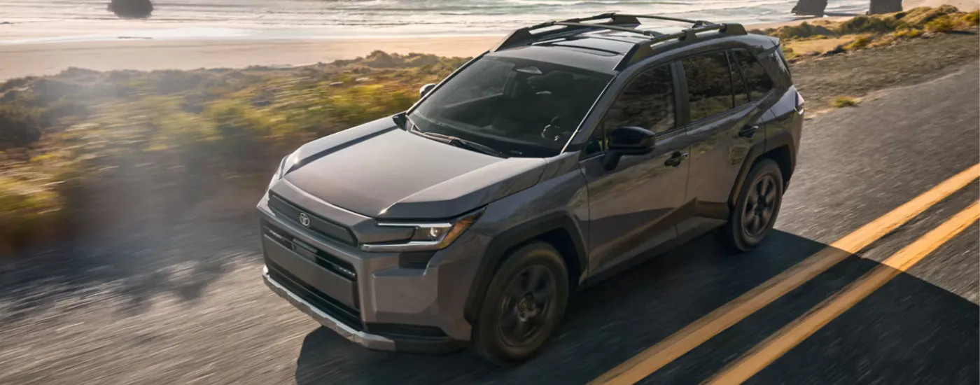 Grey 2026 Toyota RAV4 driving along a coastline