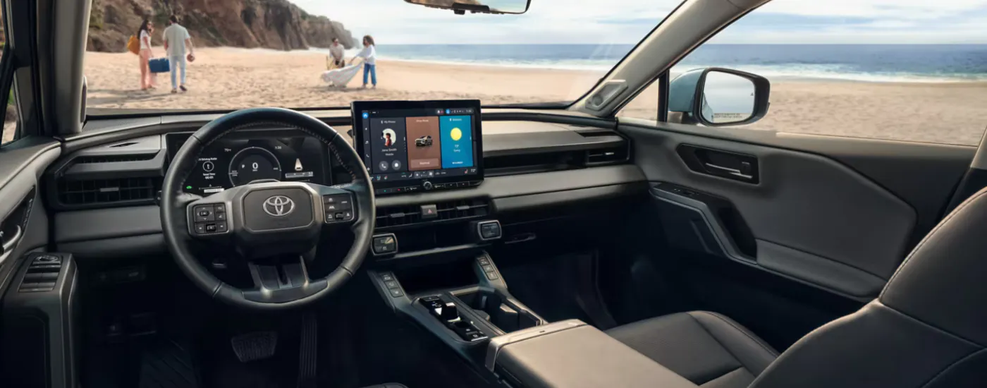Black interior of a 2026 Toyota RAV4 parked on a beach