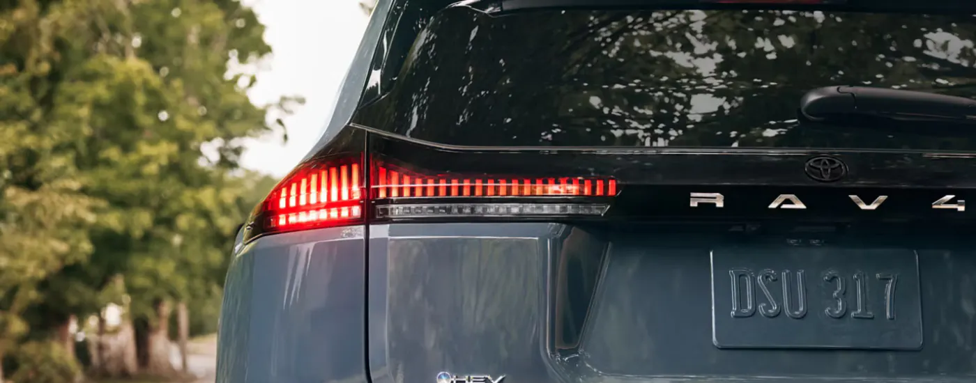 Rear badging and break light of a blue 2026 Toyota RAV4