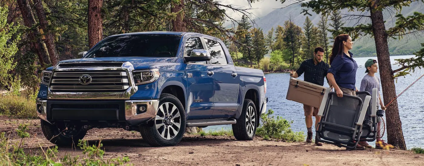 Blue 2021 Toyota Tundra parked by a lake.