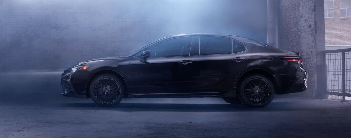 A back 2023 Toyota Camry from the side.