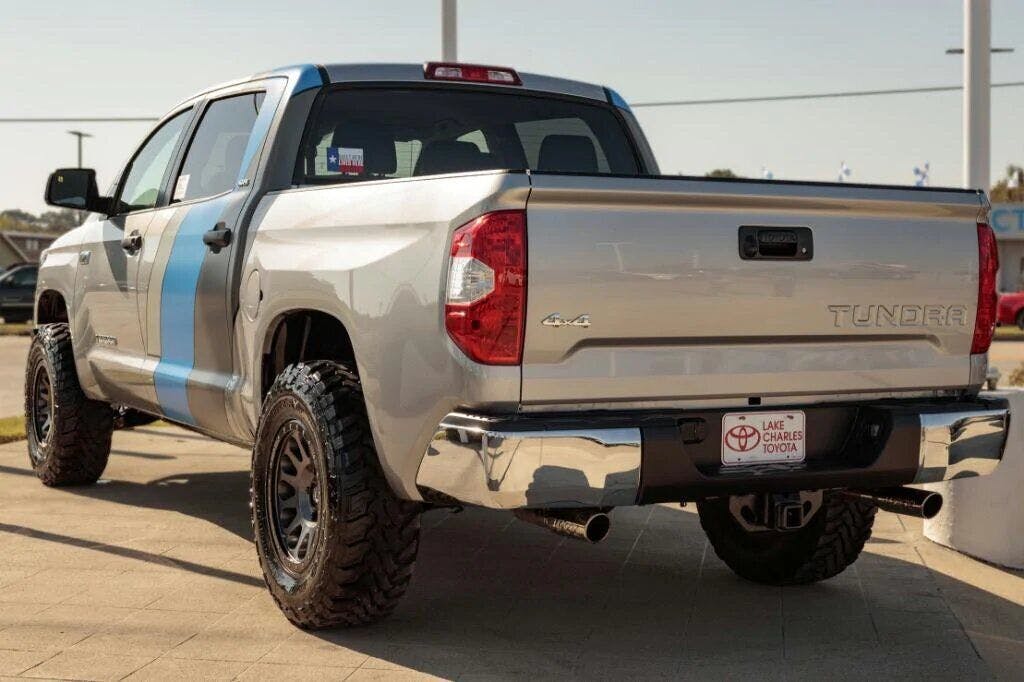 lifted silver tundra with a door decal