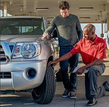 Service technician putting on a new Toyota tire.