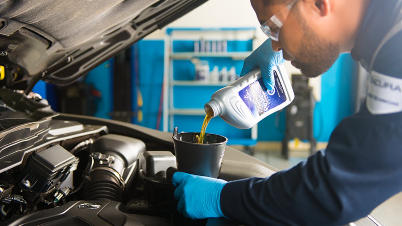 pouring oil in car