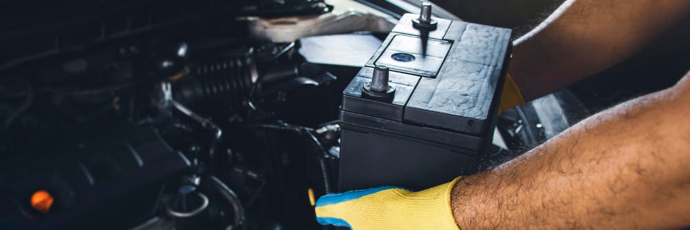 Mechanic changing car battery