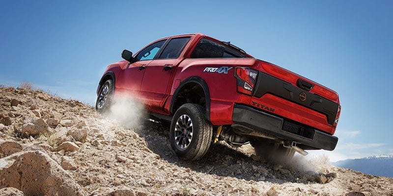Discover the 2024 Nissan Titan a red titan going up the hill