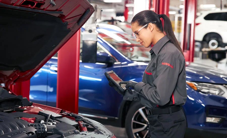 a Nissan tech check a list for inspecting a car