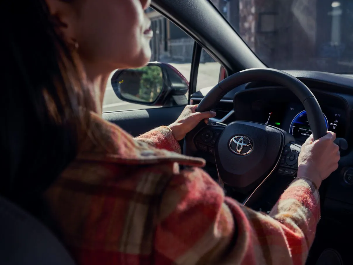 Person behind the wheel of the 2026 Toyota Corolla