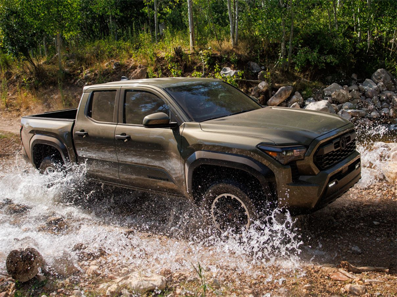 2026-Toyota-Tacoma-driving-over-stream-and-rugged-terrain