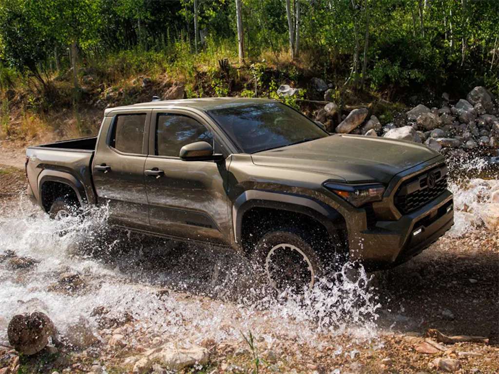2026-Toyota-Tacoma-driving-over-stream-and-rugged-terrain