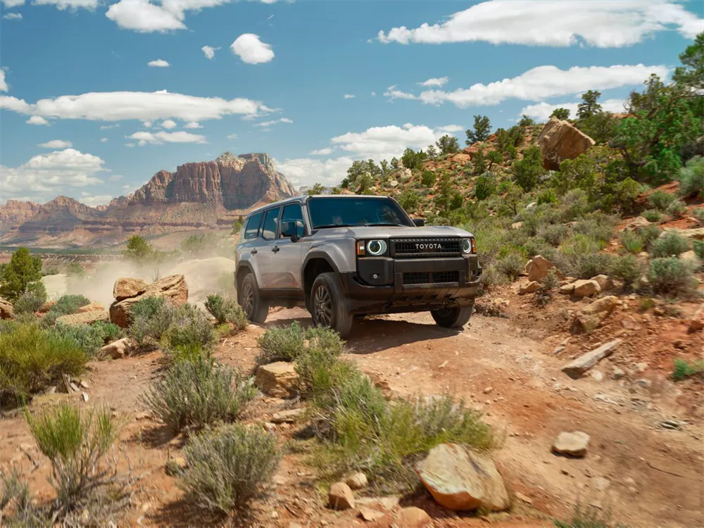2027 Toyota Land Cruiser i-FORCE MAX hybrid powertrain performing on rough off-road terrain