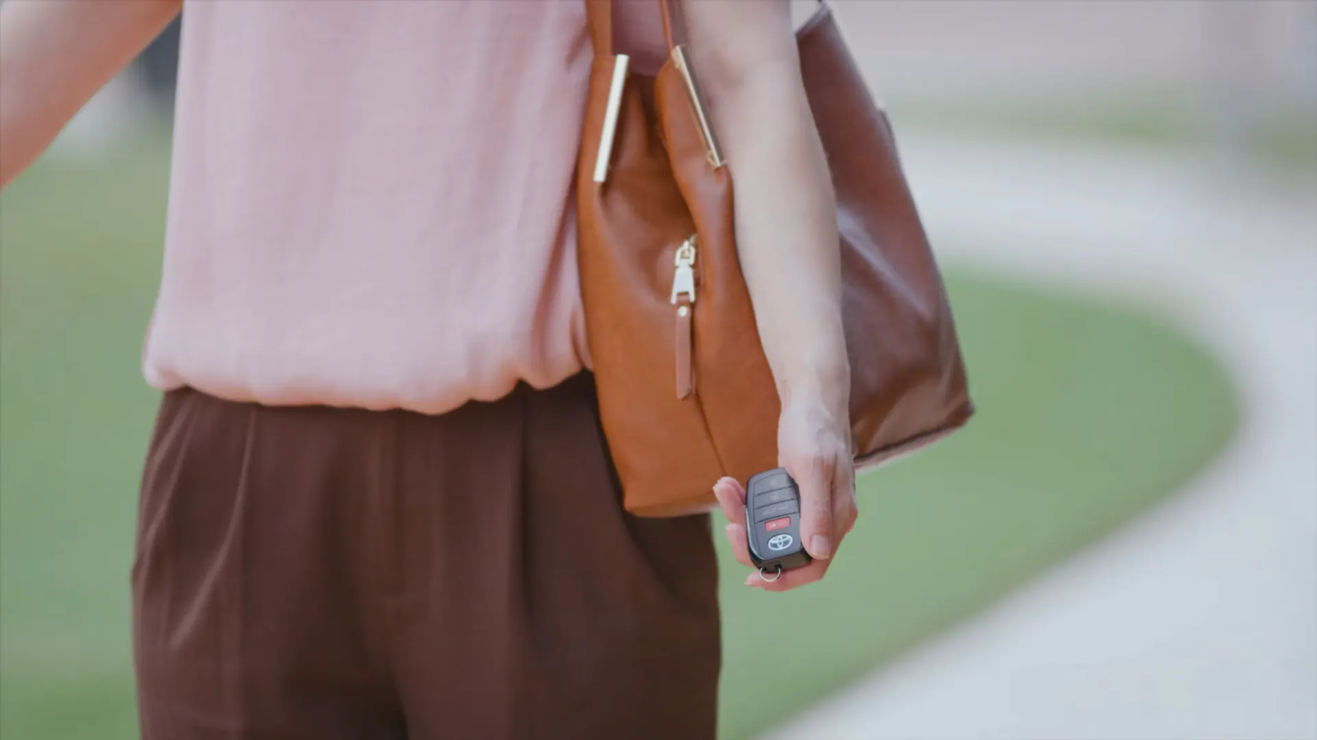 Driver holding a keyless Smart Key fob