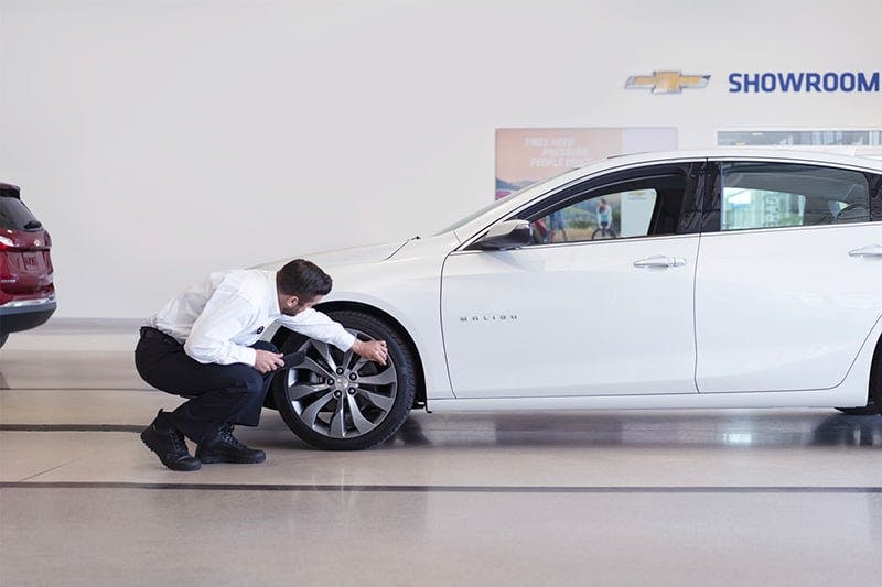 man checking tires on a car