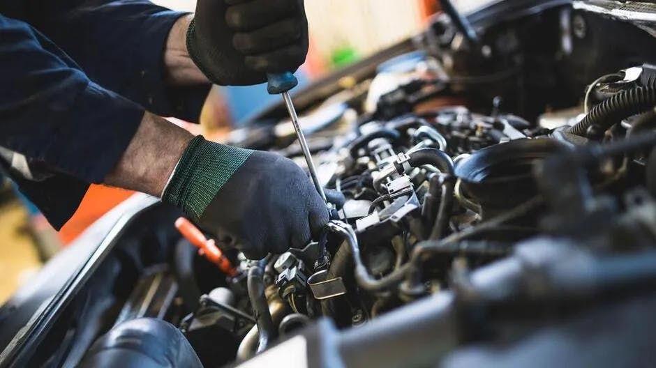 oil-change Service technician performing fluids check