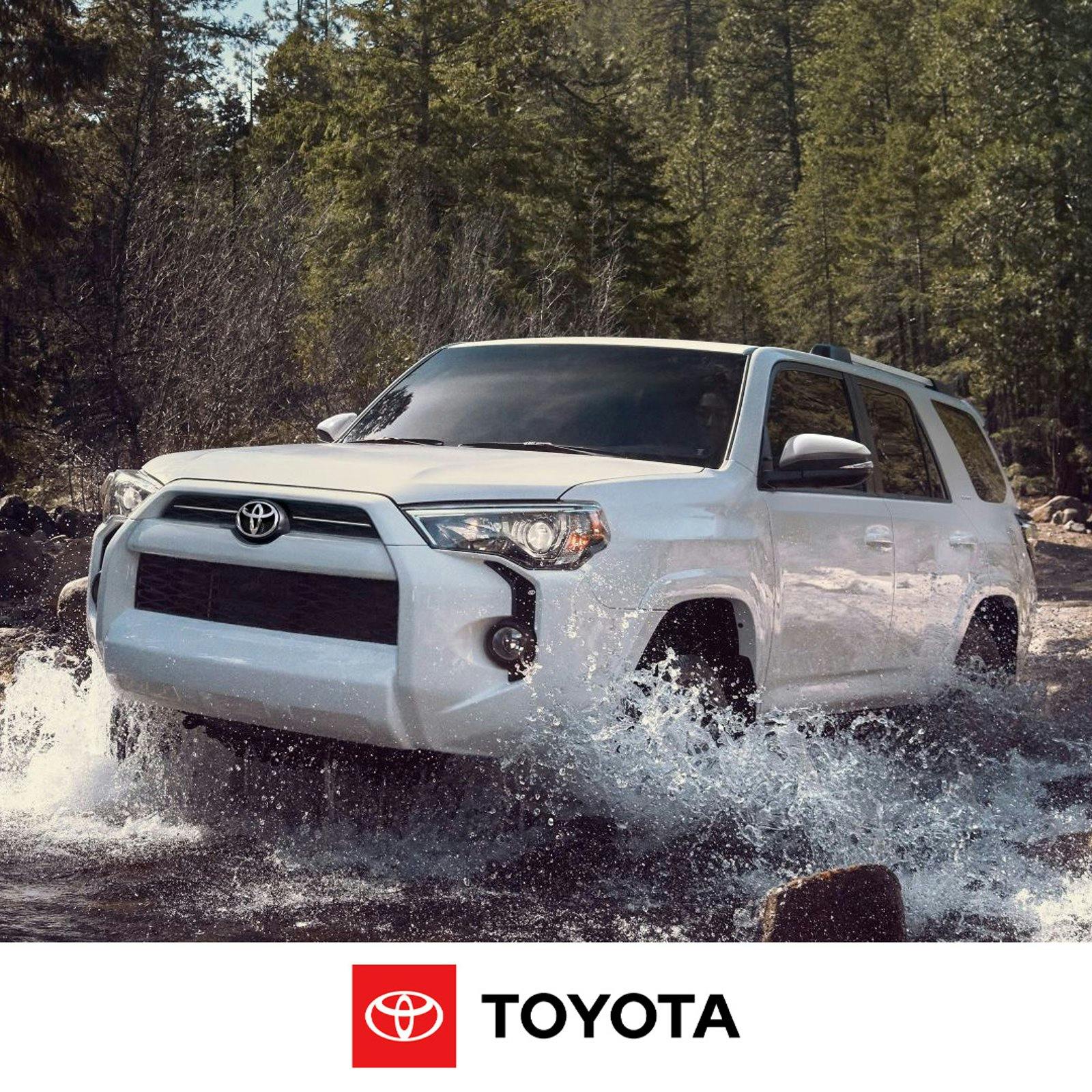4run feat A white Toyota 4Runner driving through a mountain stream with water splashing from the wheel wells