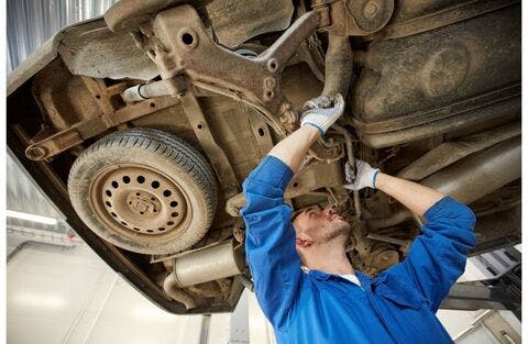 mechanic_working_underneath_dirty_car_upward_angle_-_b mechanic_working_underneath_dirty_car_upward_angle_-_b