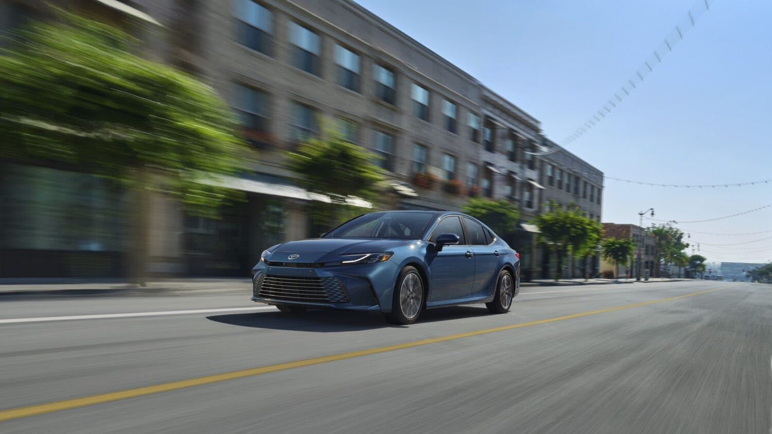 2025_Toyota-Camry_XLE driving through a main street