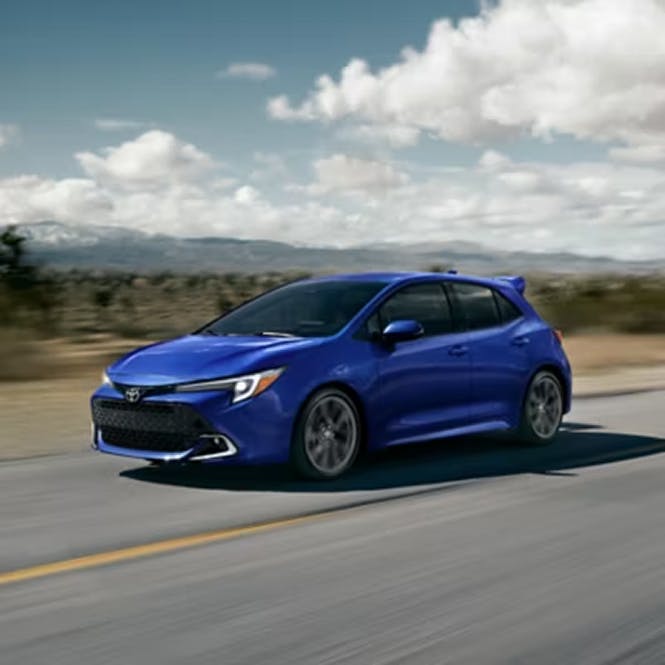 Blue Toyota Hatchback driving on the highway