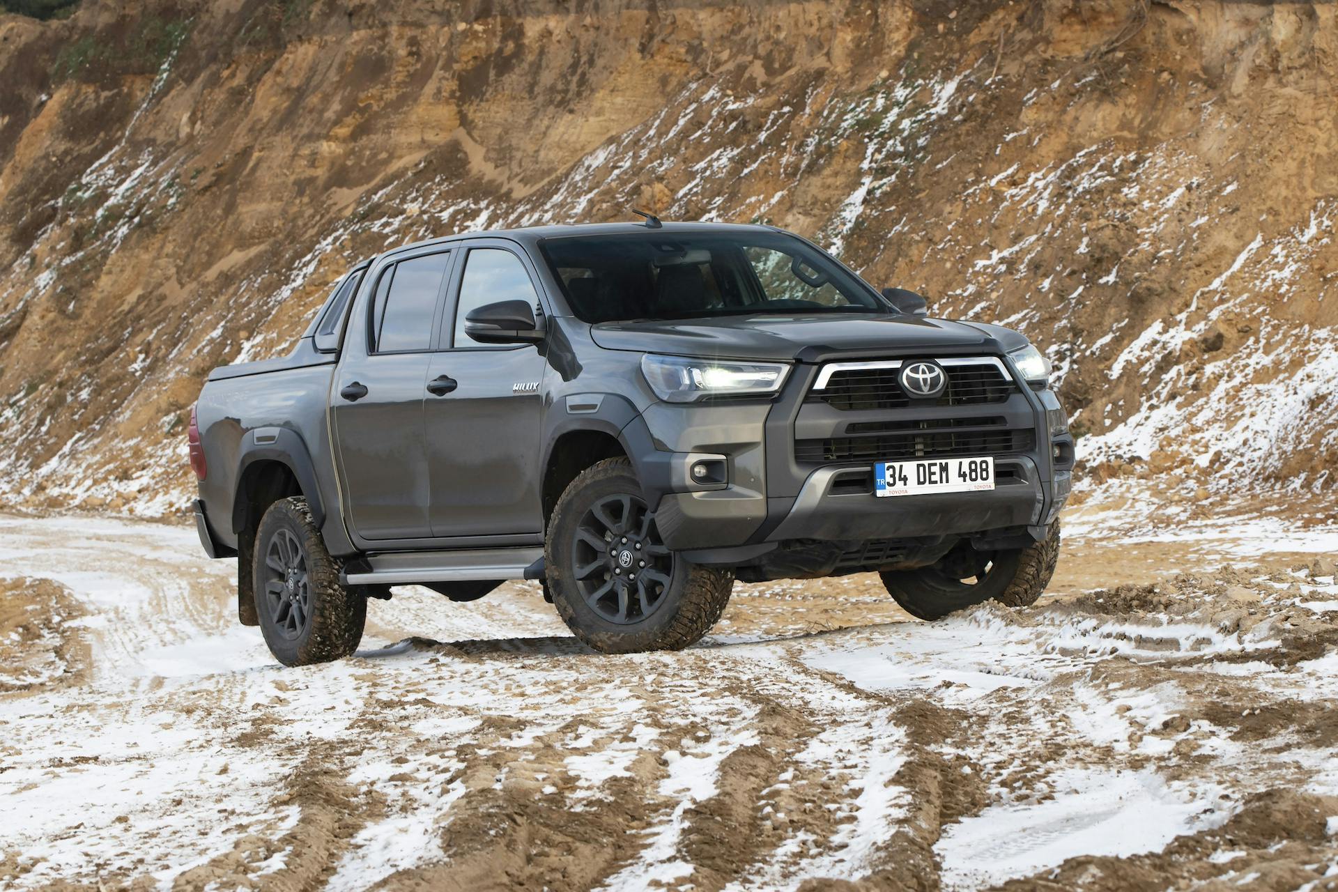 Toyota Hilux Invincible stopped on a gravel road in winter scenery. The Hilux is one of the most popular pick-up vehicles in the world.