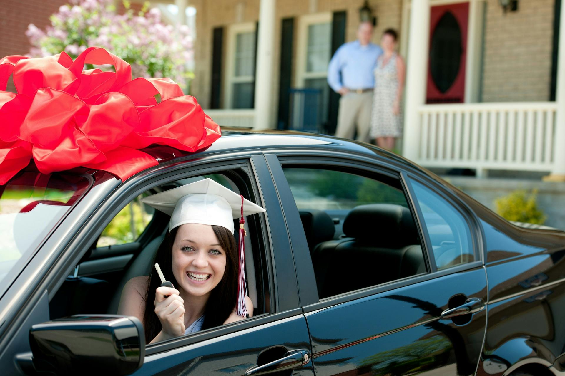 A graduate receives a car for a gift.